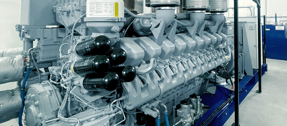 Close-up of large industrial generator engine inside facility. Close-up of large industrial generator engine inside facility.