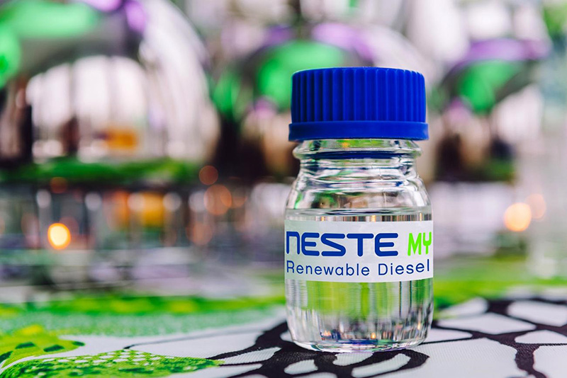 Neste MY Renewable Diesel bottle with blue cap on laboratory table. Neste MY Renewable Diesel bottle with blue cap on laboratory table.